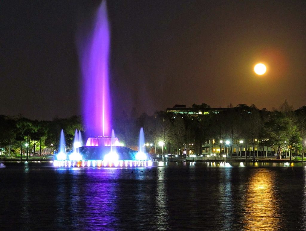 Lake Eola Park fountain lit up at night in downtown Orlando